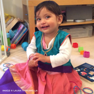 a mixed race child smiling at camera